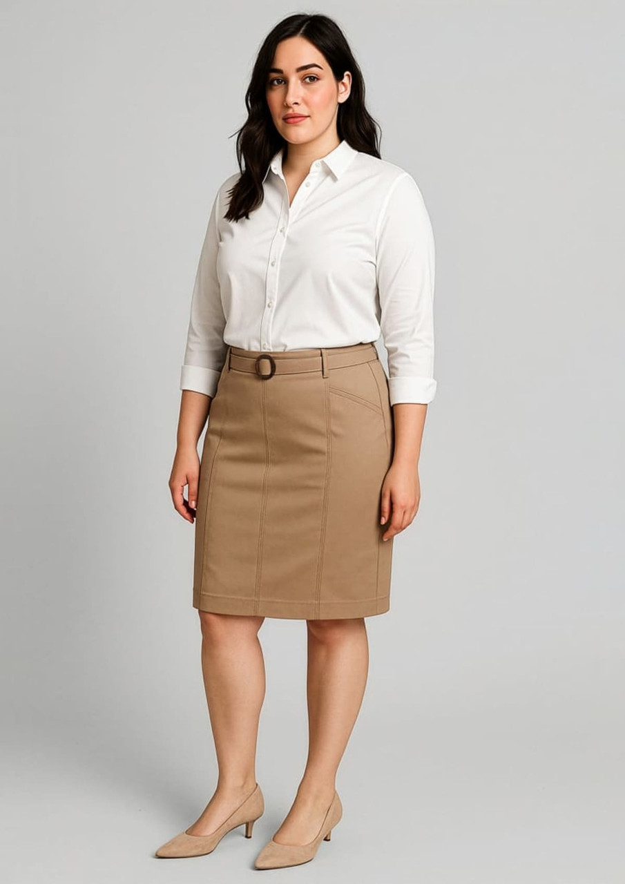 A woman stands wearing a beige mid waist stretch chino skirt and a white shirt, with a logo visible on the skirt.