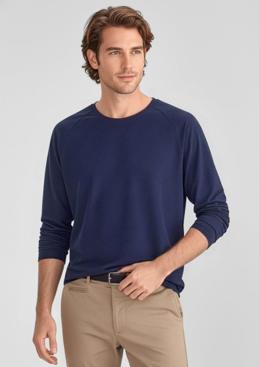 A navy long sleeve tee for men, featuring a relaxed fit and a logo. Paired with light-coloured pants.