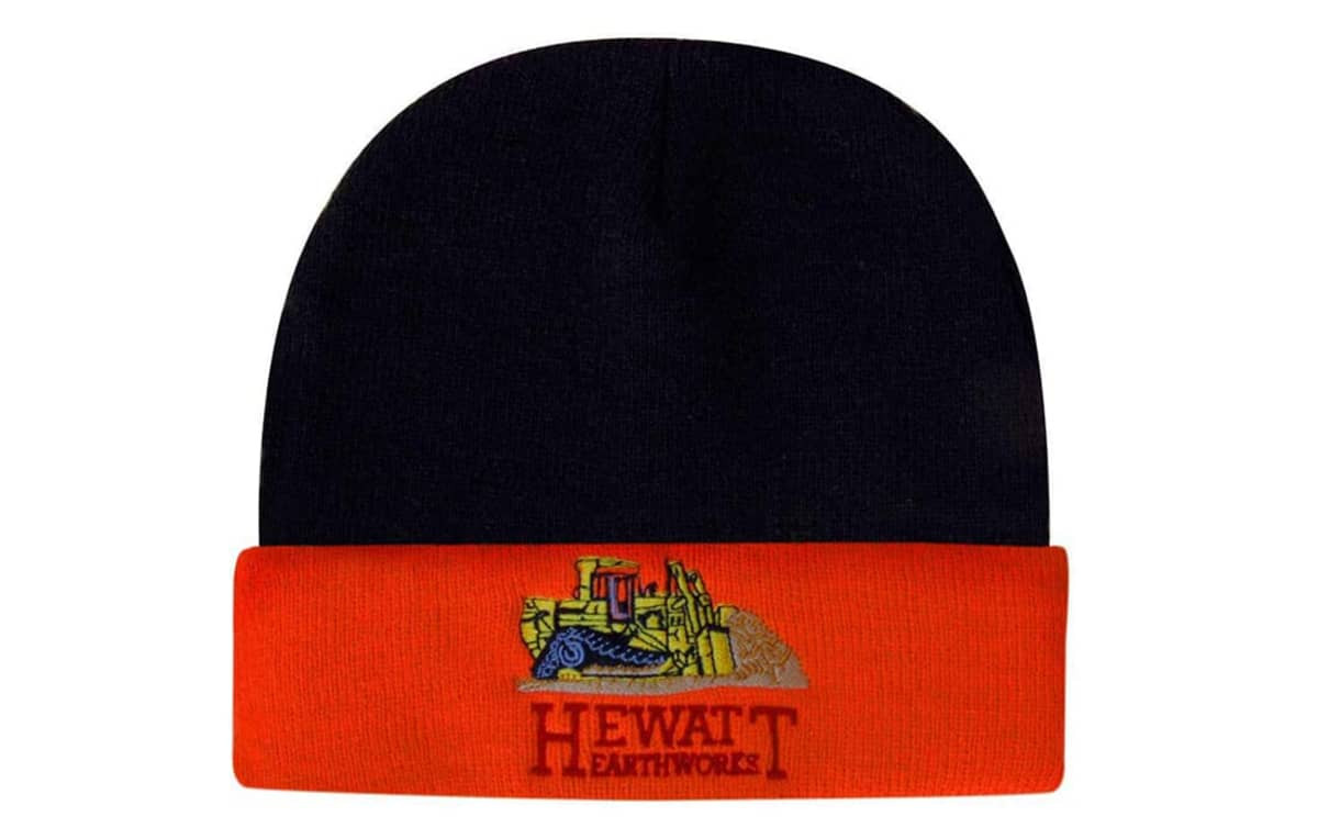 A beanie in navy and orange featuring a logo and an illustration of construction equipment.