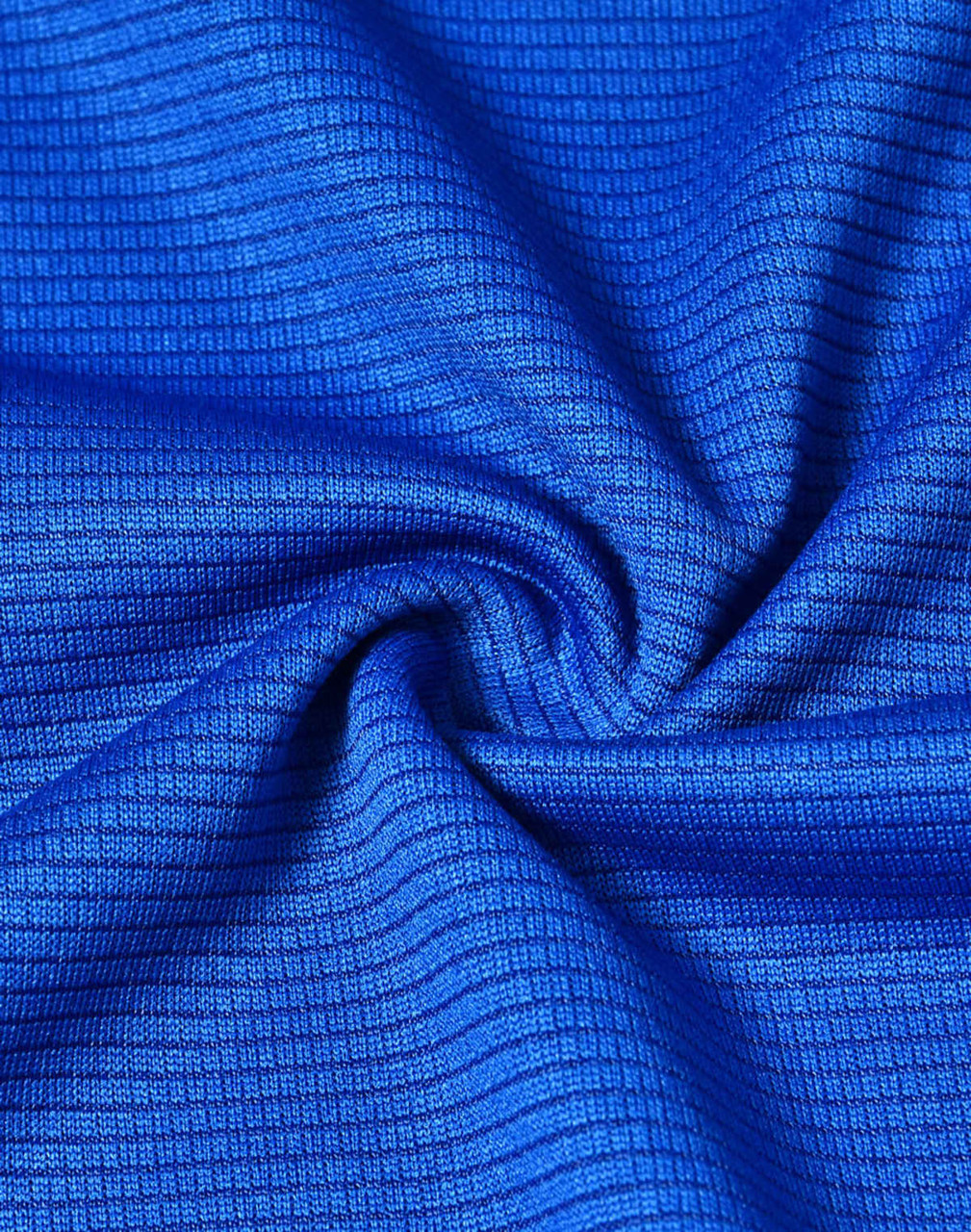 A close-up of blue textured fabric, showcasing a lightweight and performance-oriented material.