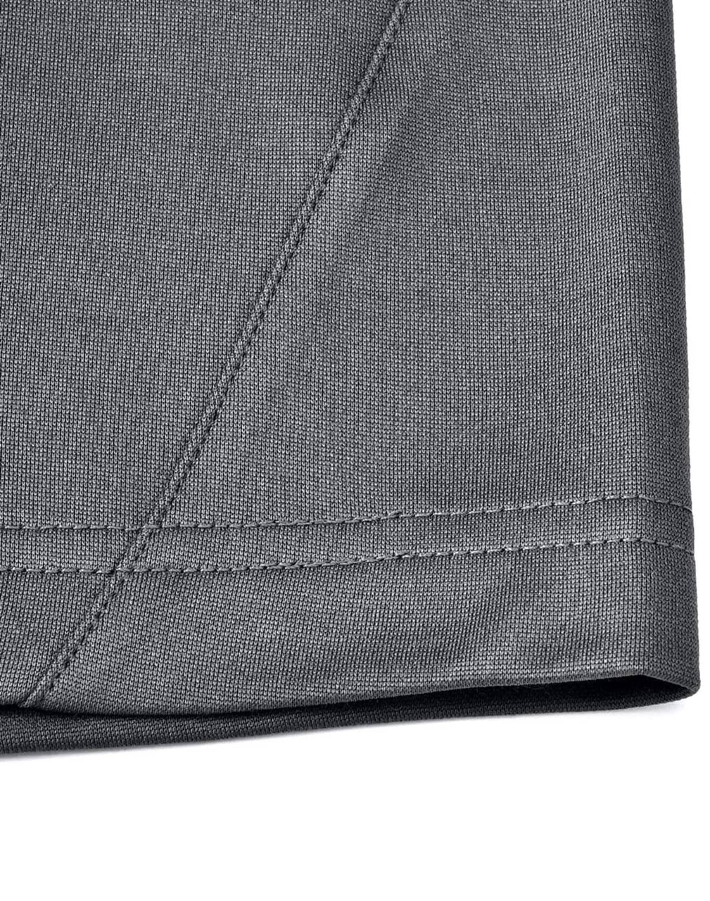 A close-up of the hem and fabric of a grey men's sustainable polo shirt, featuring a stitched edge.