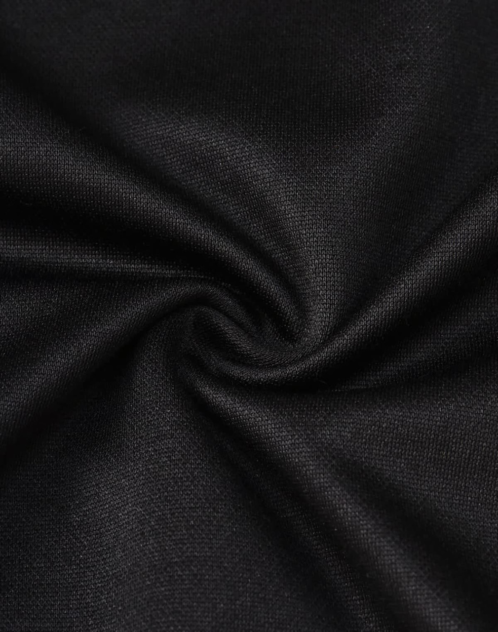 A close-up of black sustainable poly/cotton fabric, showcasing a smooth and sleek texture.