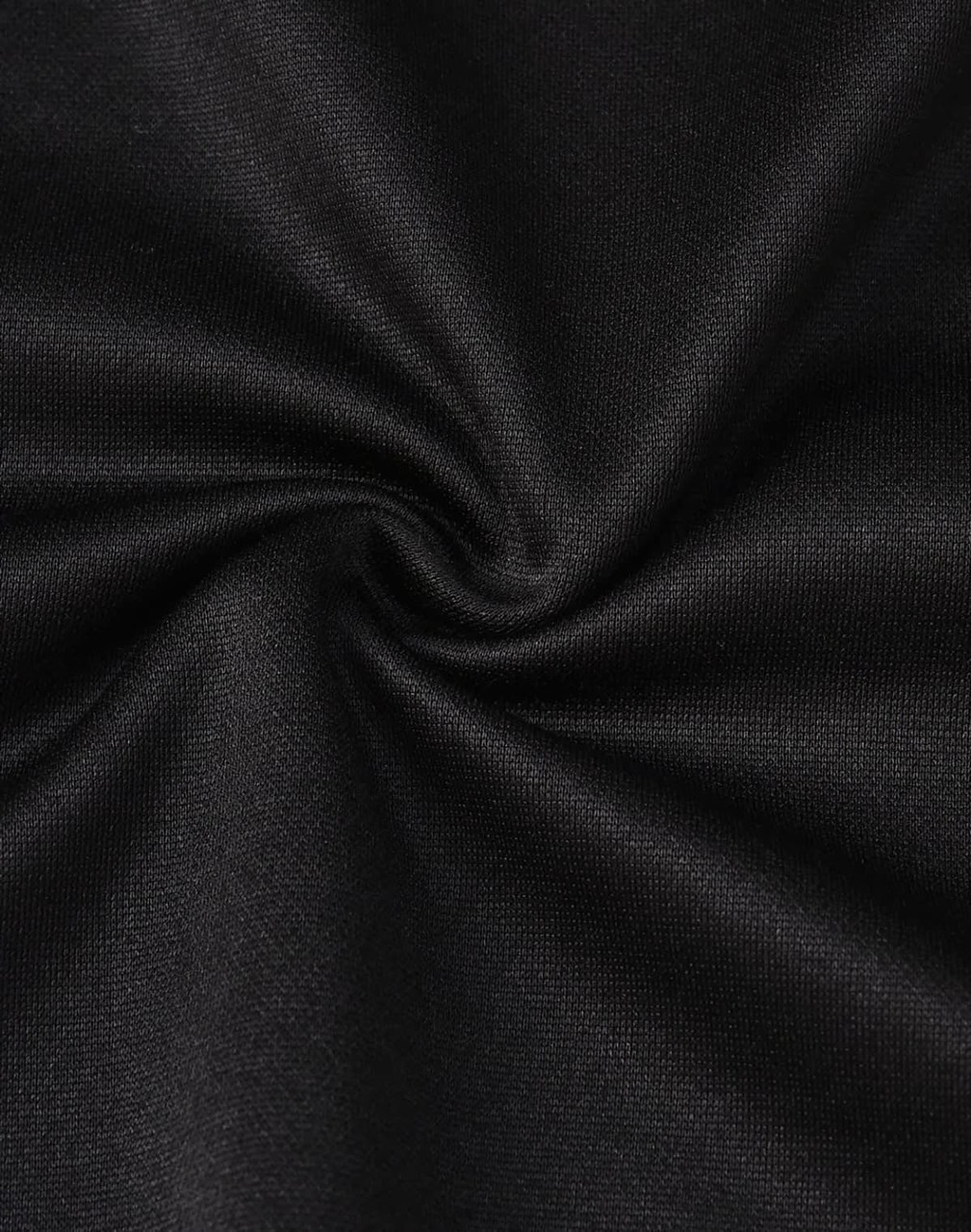 A close-up of black fabric, featuring a smooth texture with a slight stretch, suitable for polo shirts.