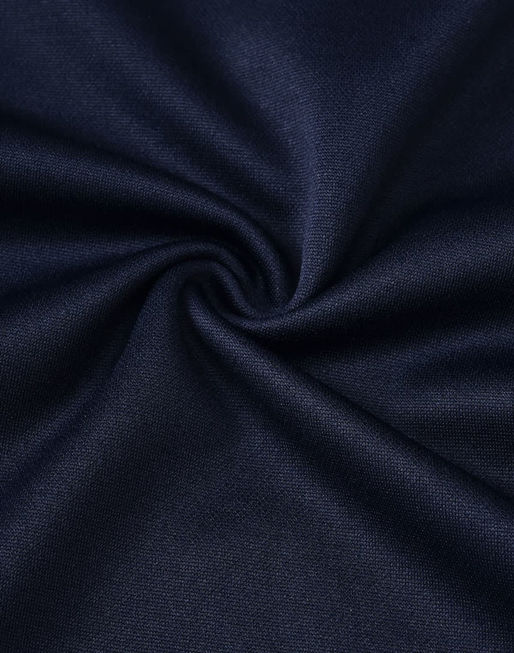 A close-up of dark navy fabric, showing a smooth, textured weave ideal for polo shirts.