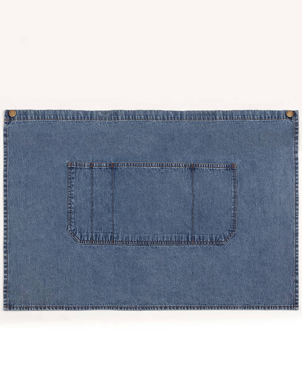 A denim half apron in blue with a front pocket and brass button accents. It has a simple, functional design.