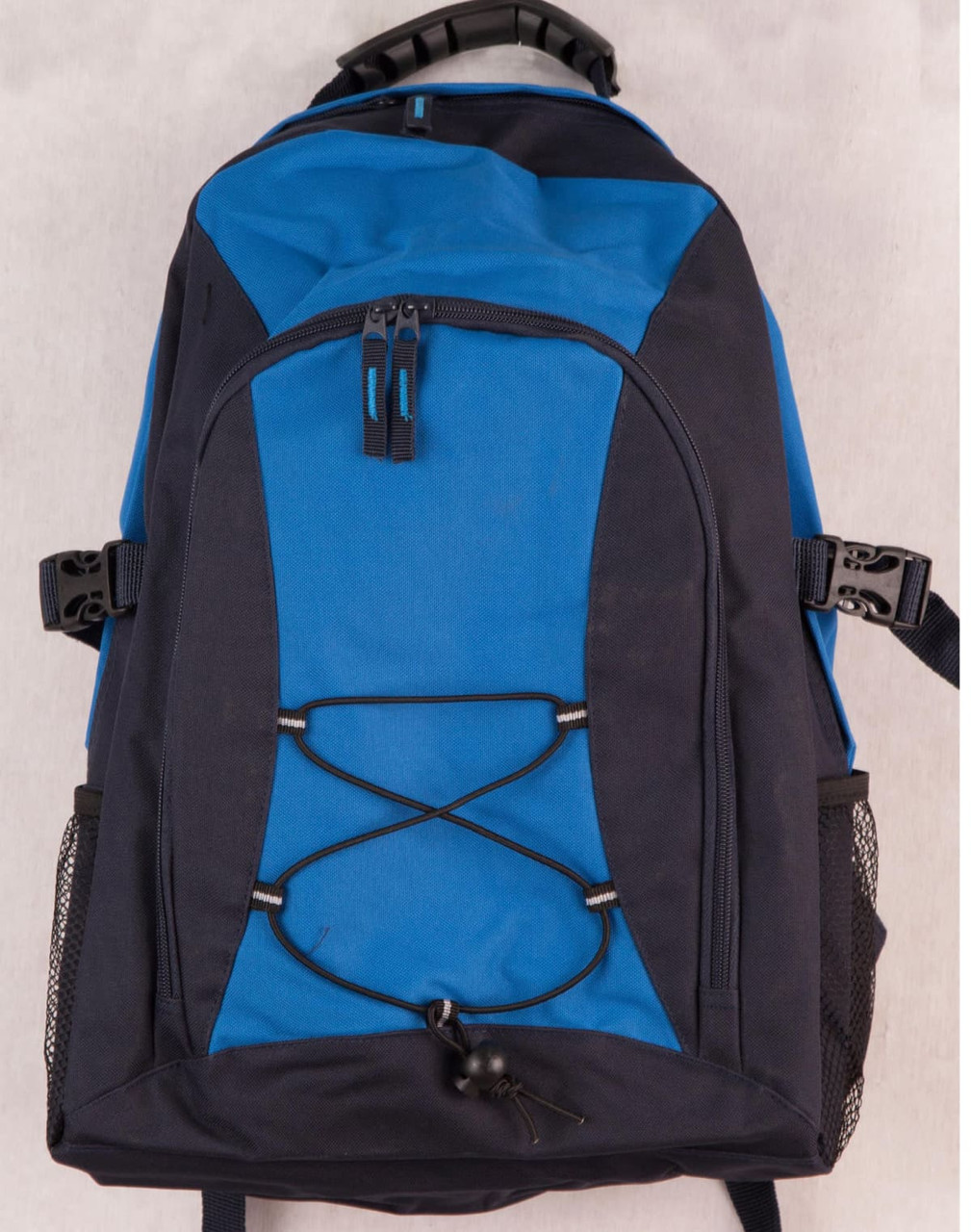 A blue and navy backpack with multiple compartments, a front bungee cord design, and side mesh pockets.