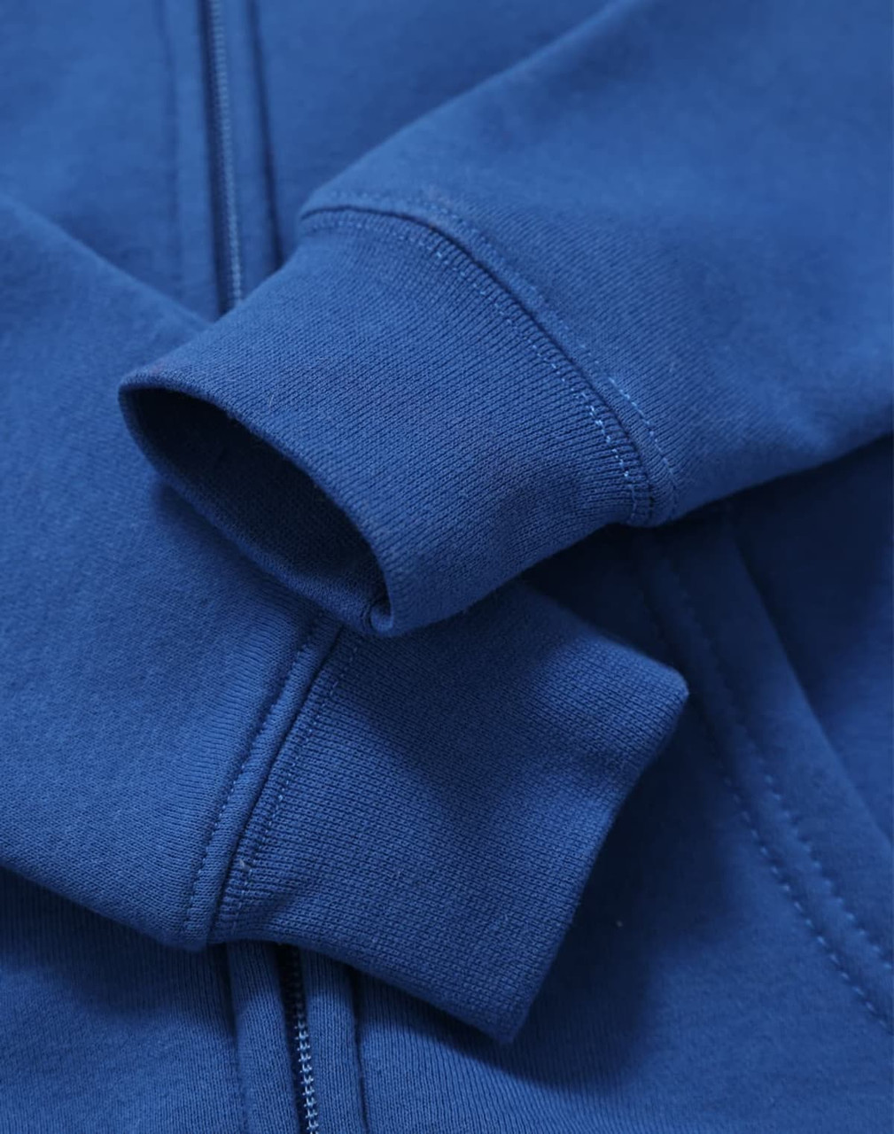 A blue full-zip fleecy hoodie featuring a logo and ribbed cuffs.