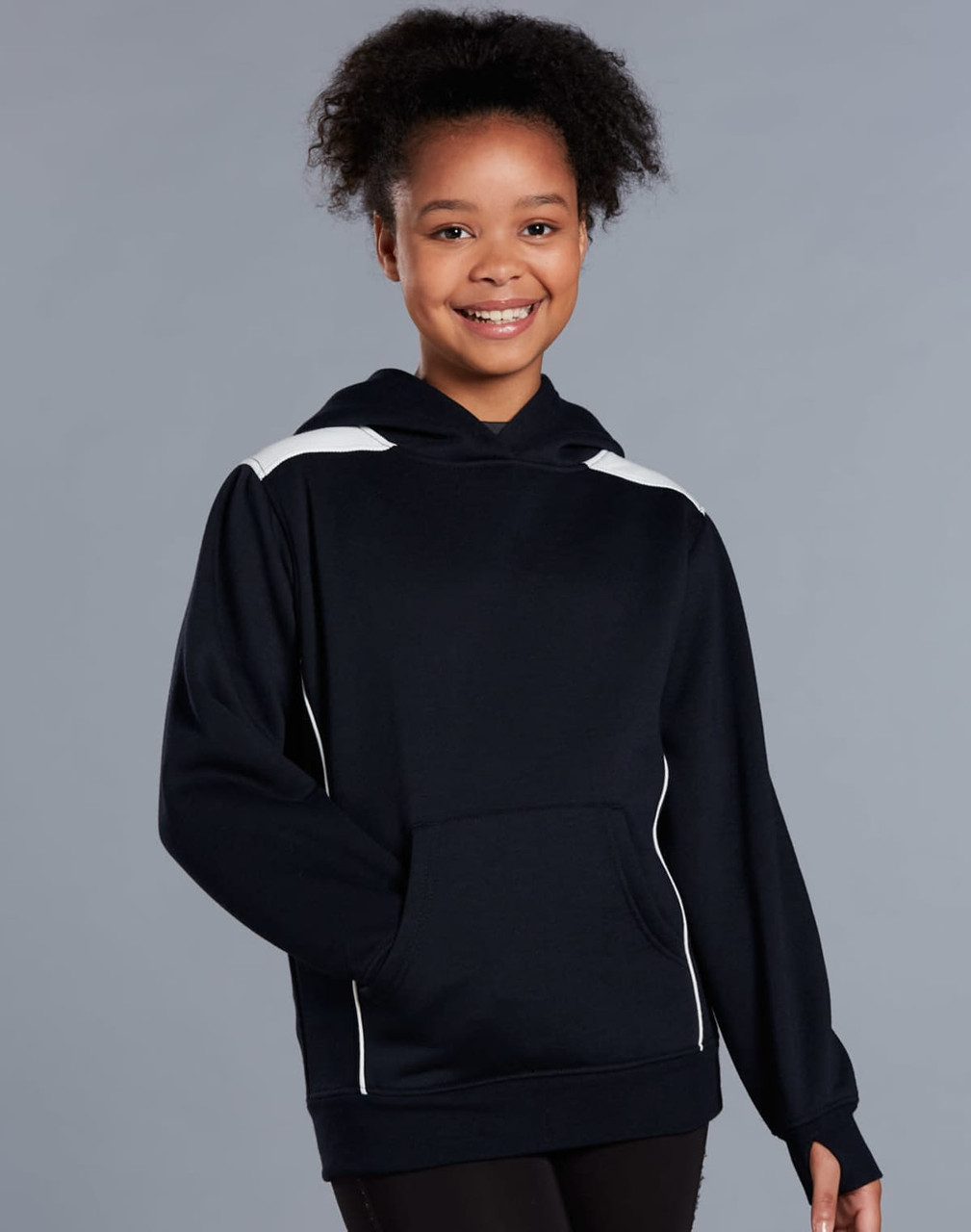 A girl wearing a navy hoodie with a kangaroo pocket and contrasting white accents. The hoodie features a logo.