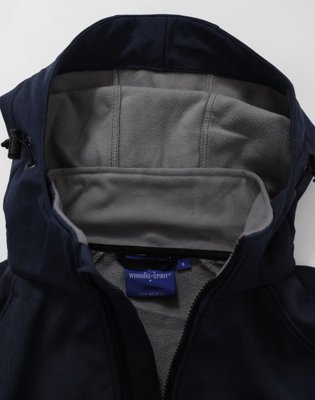 A navy softshell full zip hoodie with a grey fleece-lined interior and hood. Features a small logo inside.