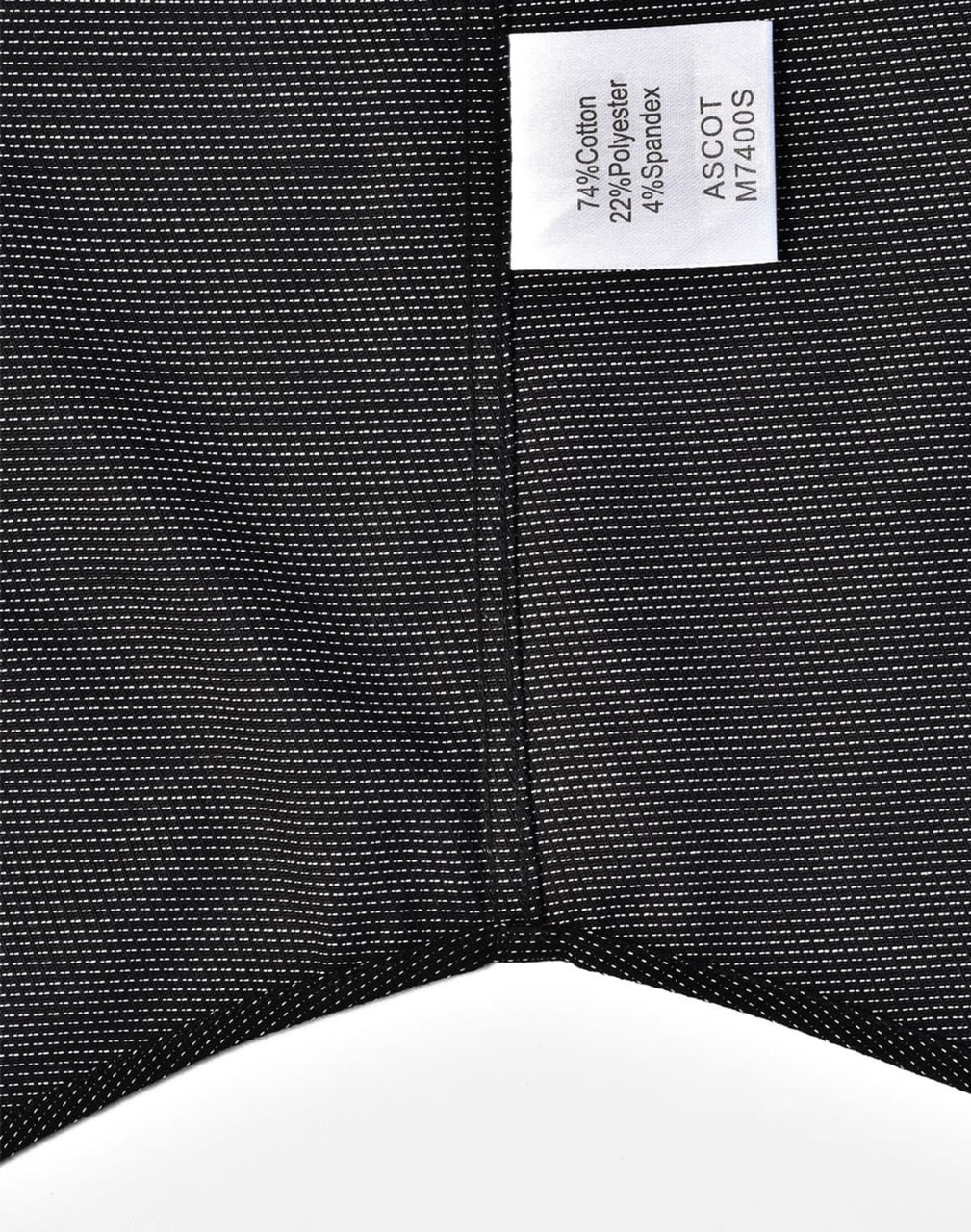 A black pin dot stretch short-sleeve shirt with a care label and a subtle pattern. Features a logo on the label.