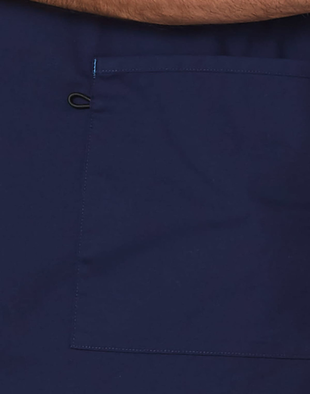 A navy scrub top featuring a large pocket and contrast brown collar. Includes a logo.