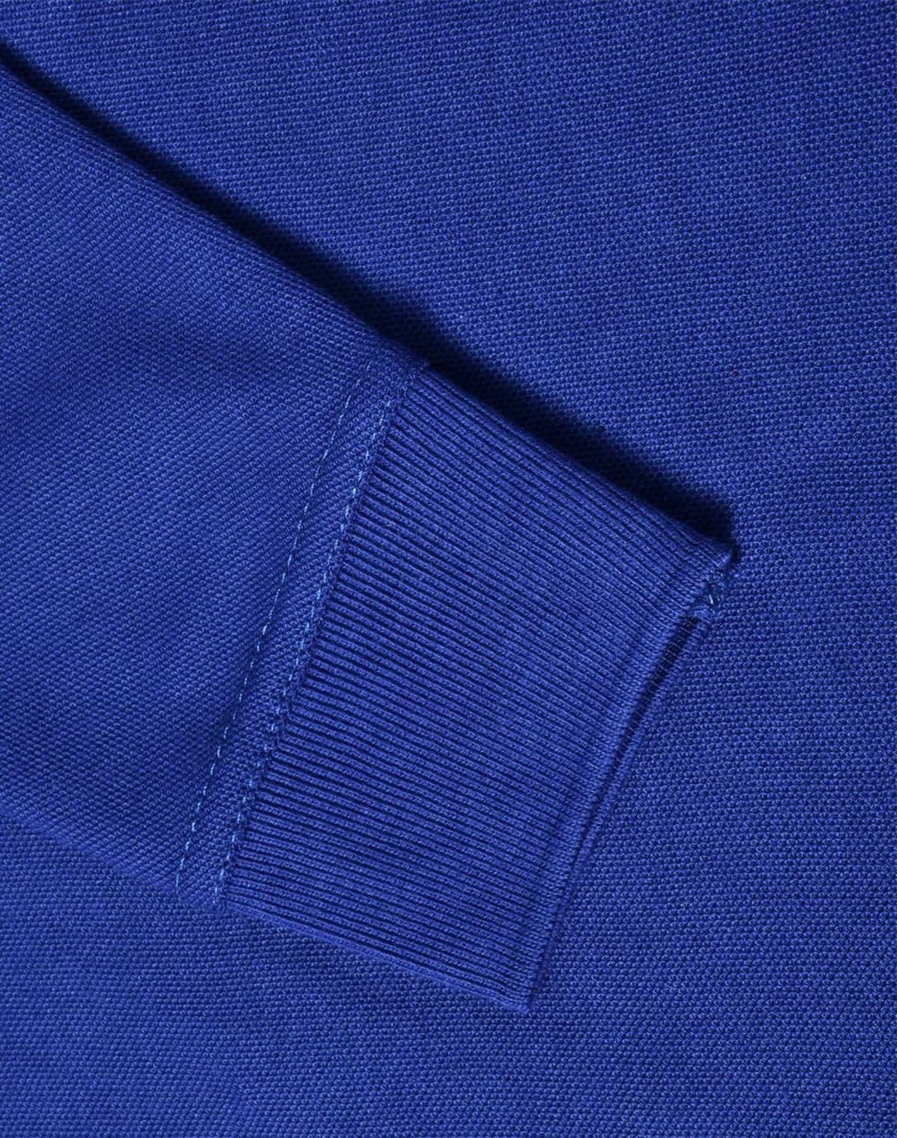 A close-up of a blue long sleeve polo shirt, showcasing the knit texture and ribbed cuff detail.