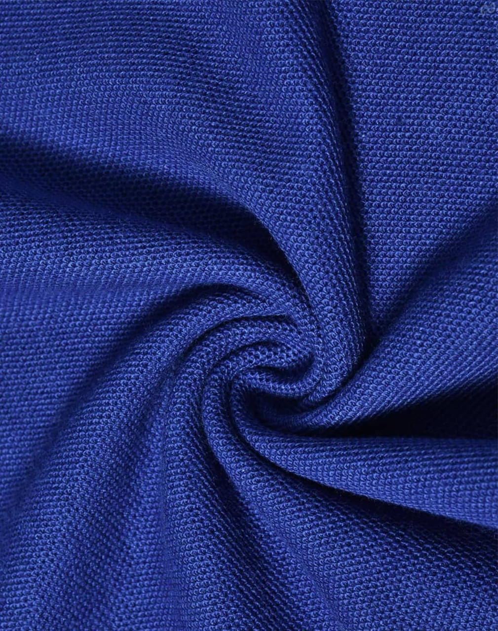 A close-up of textured blue fabric, showcasing the knit pattern of a poly/cotton pique material.
