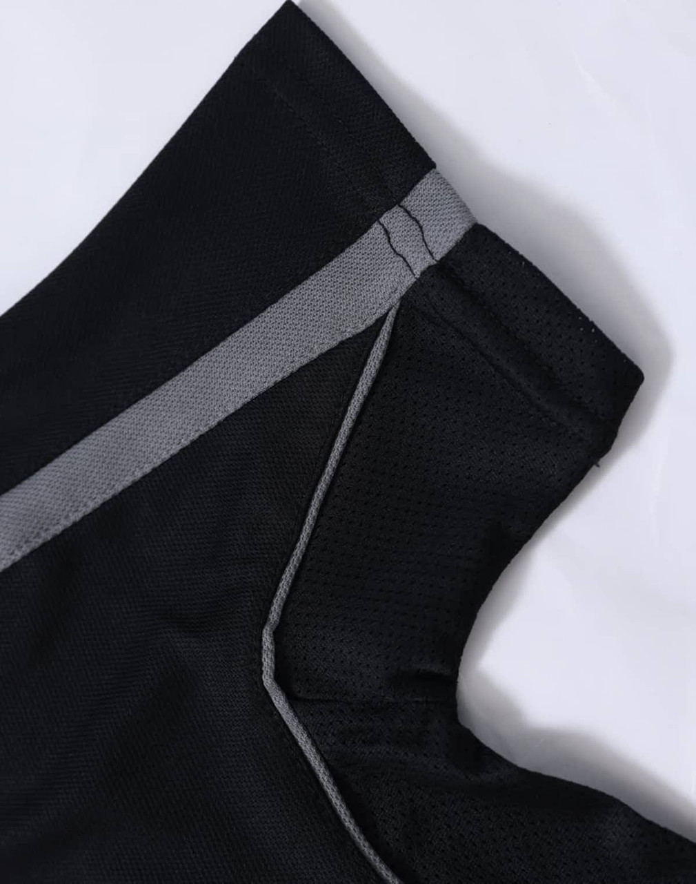 A black polo shirt with grey detailing on the collar and sleeves, featuring a logo.