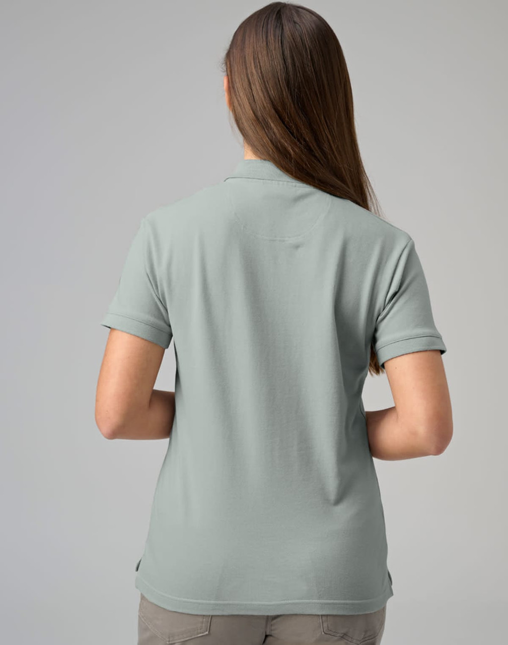 A ladies cotton stretch polo shirt in a muted green colour, featuring a collar and short sleeves.