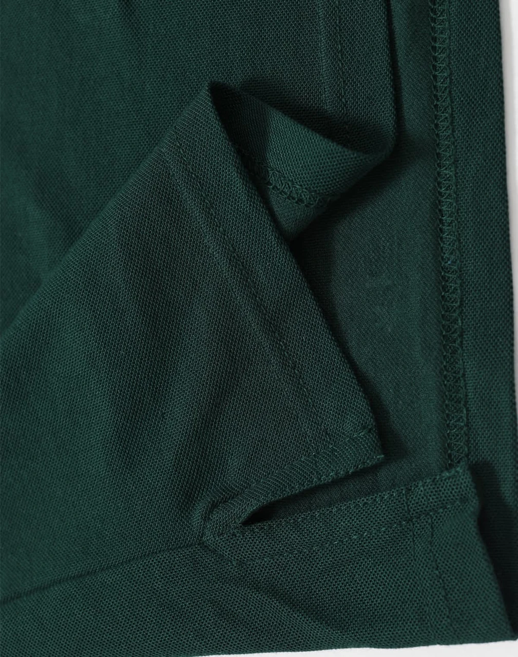 A dark green men's polo shirt featuring a folded hem and stitching details, including a logo.
