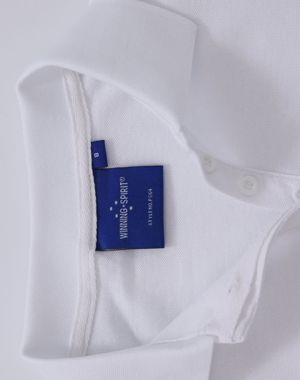 A white polo shirt featuring a tag and a collar. The shirt has buttons and a branding logo.