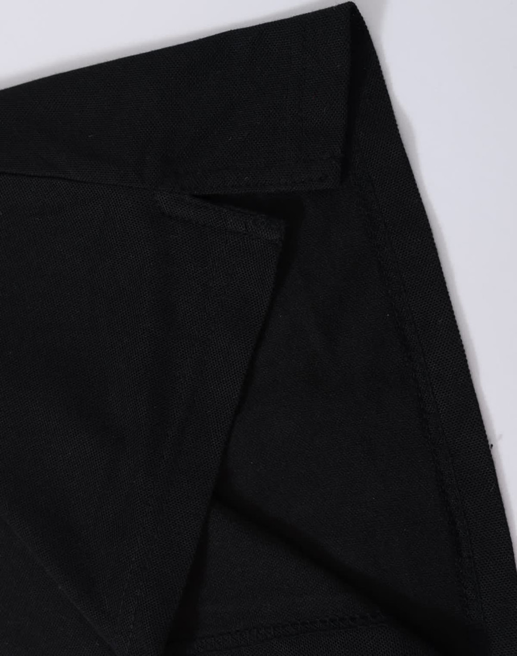 A black polo shirt featuring a classic collar and a logo, highlighting the fabric texture and stitching details.