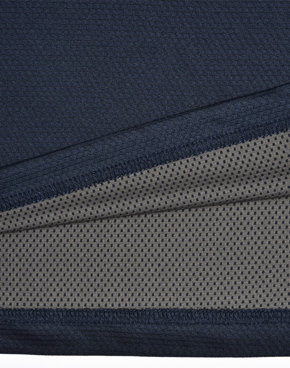 A close-up of a navy blue men's polo shirt featuring a textured fabric with a contrasting inner layer.