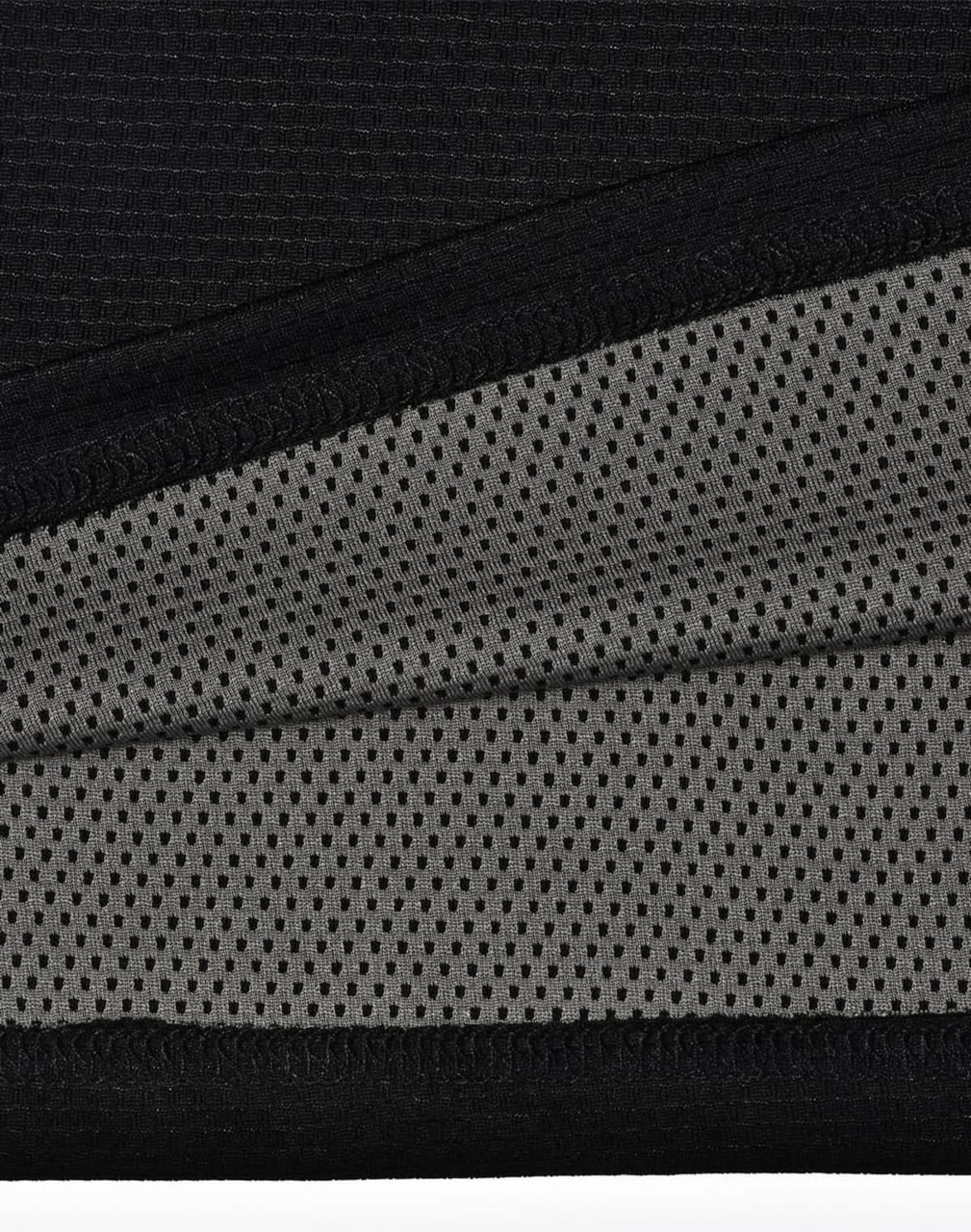 A close-up of a black polo shirt featuring a breathable grey mesh fabric beneath. The shirt includes a logo.