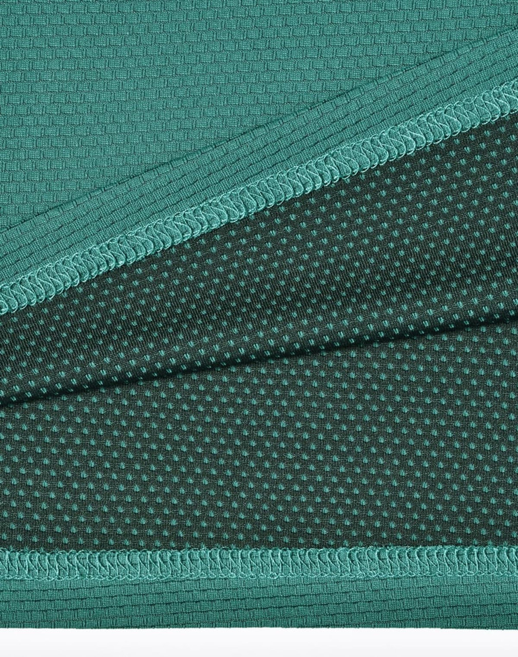 A fabric close-up of a teal bamboo charcoal polo shirt, featuring textured and dotted patterns.