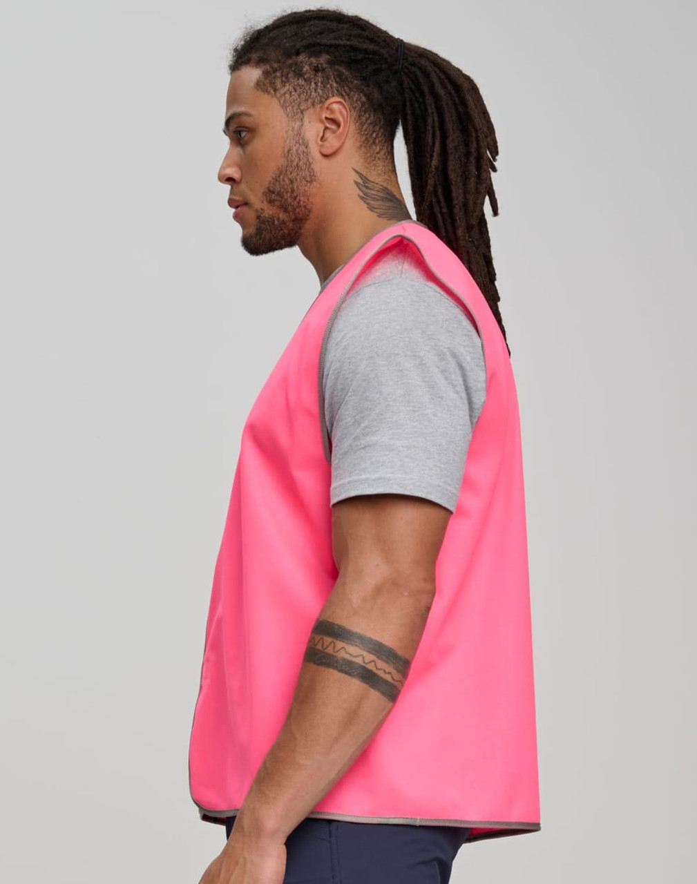 A pink Hi-Vis safety vest displayed on a model, featuring a simple, reflective design.