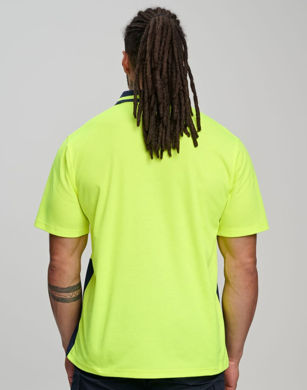 A Hi-Vis yellow safety polo shirt with a navy trim, featuring a logo on the back.