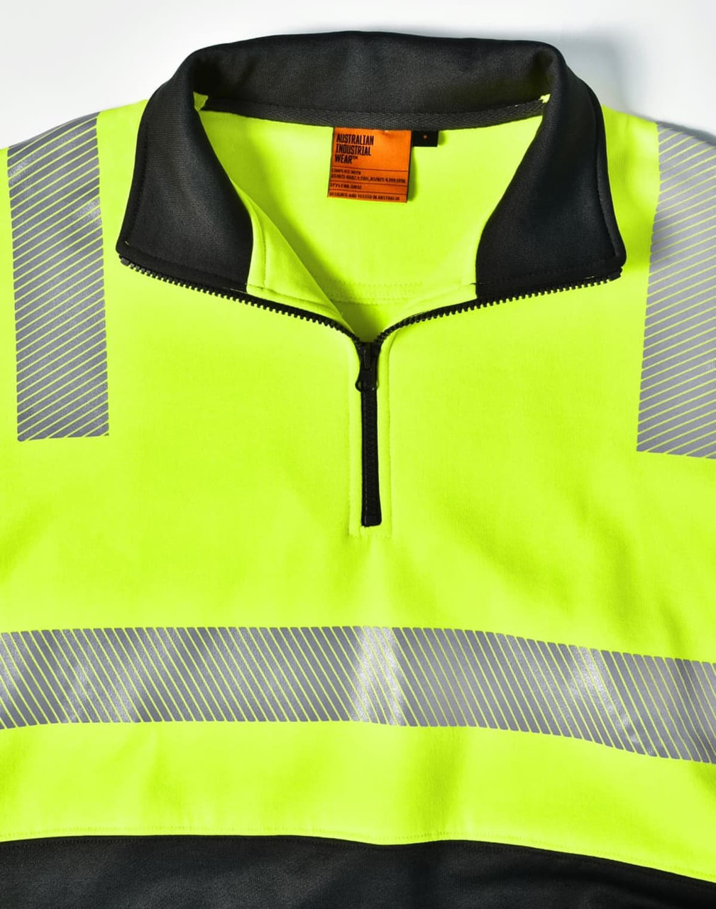 A high-visibility jumper in fluorescent yellow and black, featuring reflective stripes and a zippered collar.