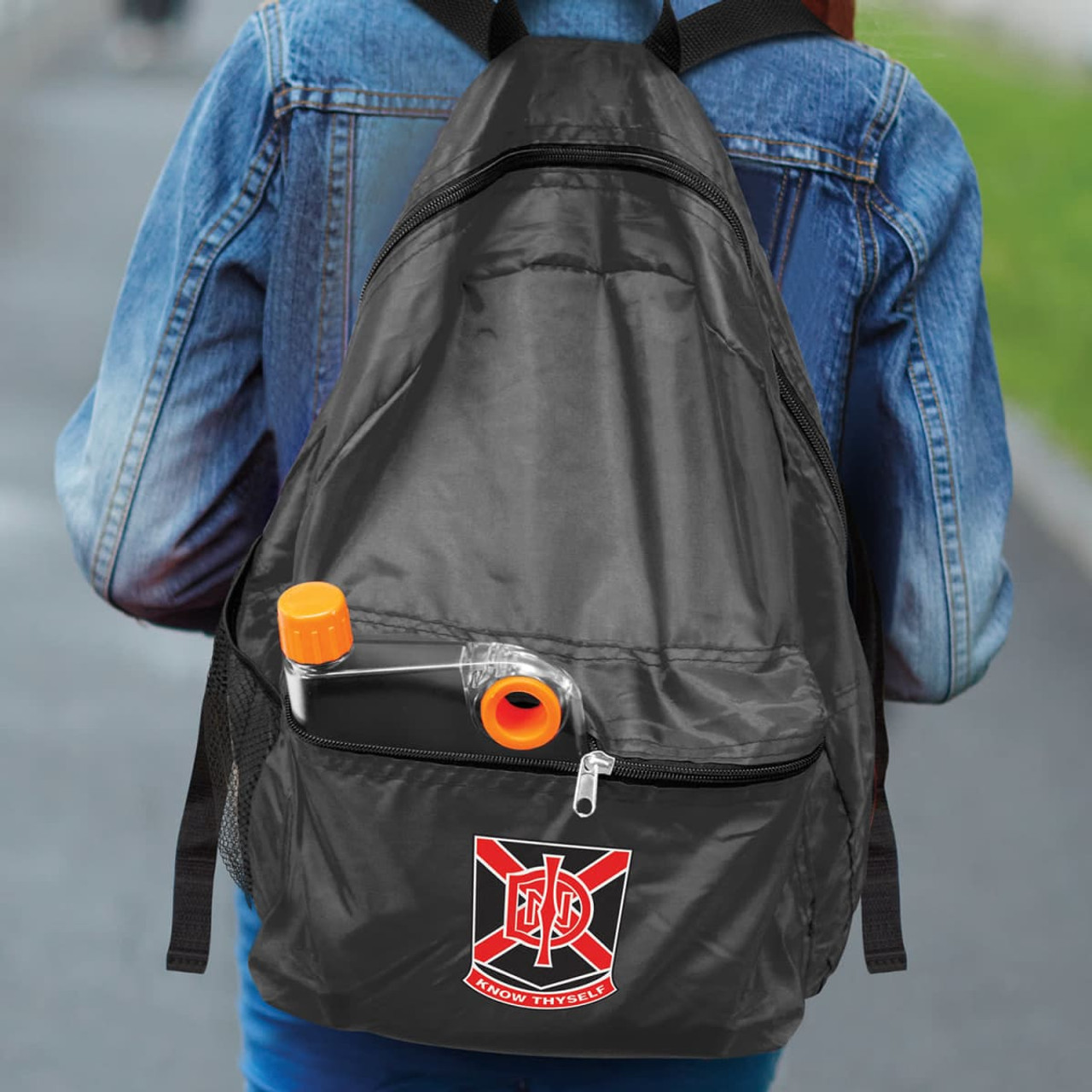 A black backpack with a logo and a drink bottle tucked into the front pocket, carried by a person wearing a denim jacket.