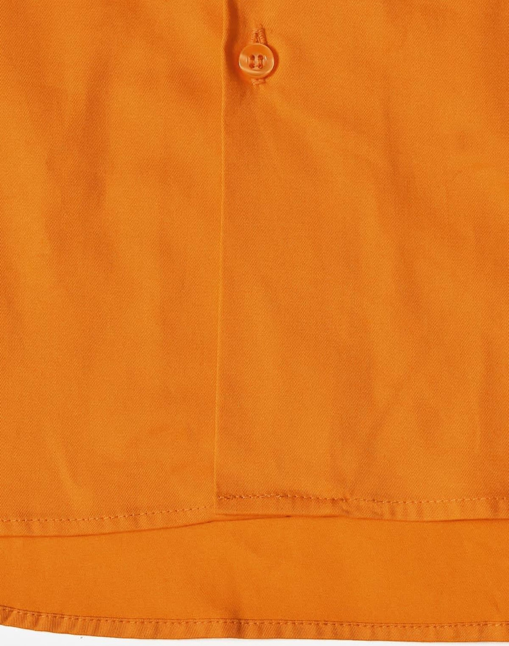 An orange work shirt with a button detail, featuring stitching and a fabric texture. It has a logo.