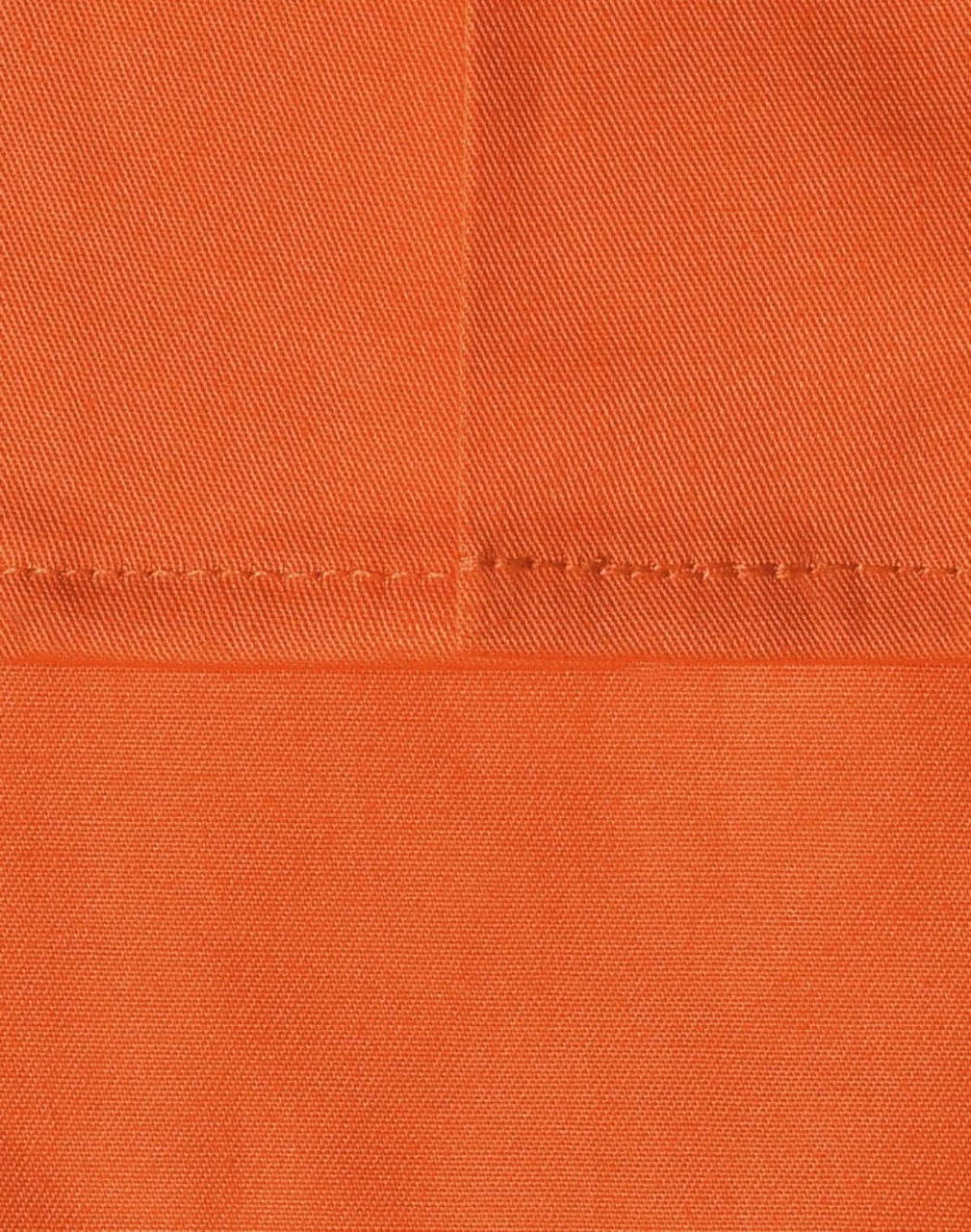 An orange fabric swatch featuring a close-up of stitching details, ideal for workwear applications.
