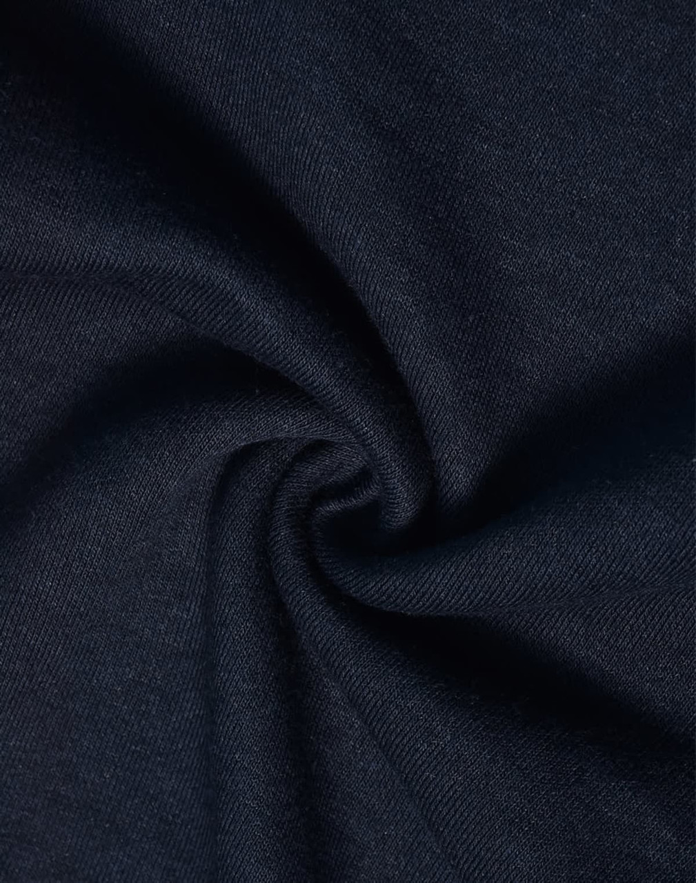 A close-up of dark navy fabric with a smooth, soft texture, showcasing a poly/cotton blend.
