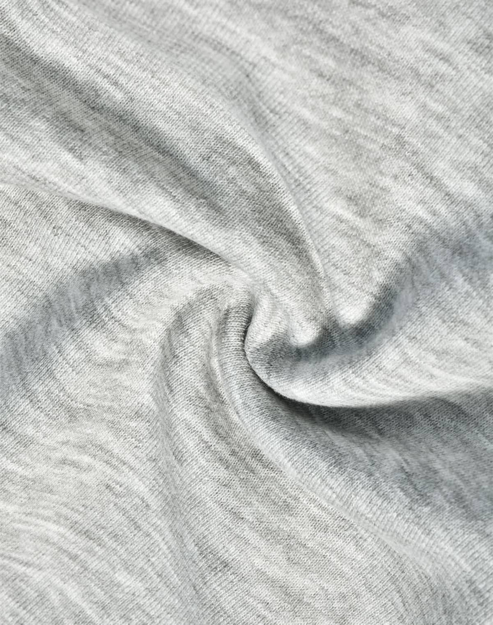 A close-up of light grey fabric, showcasing the soft texture of poly/cotton terry.
