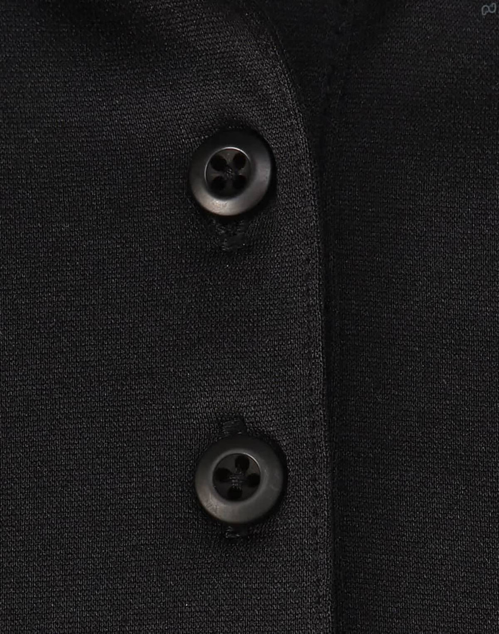 A close-up of a black polo shirt featuring buttons and a subtle texture, highlighting its sustainable fabric.