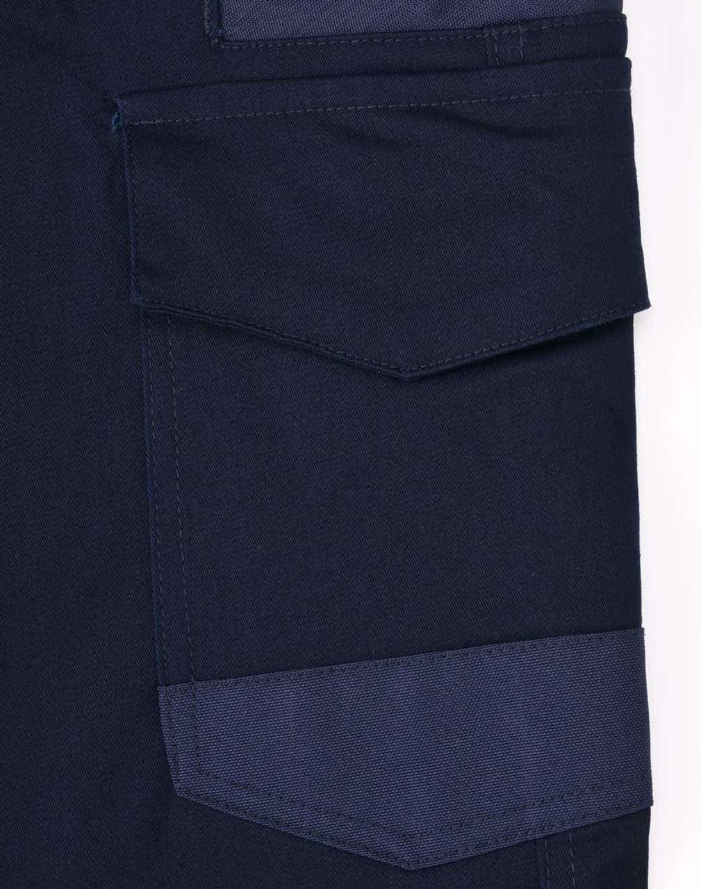 A close-up of navy blue unisex cotton stretch drill work pants featuring a side pocket and patch detail.