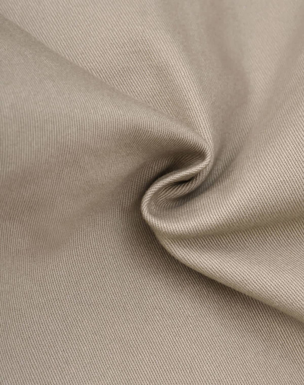 A close-up of beige fabric showcasing the texture of cotton stretch drill material. The image features a subtle shine.