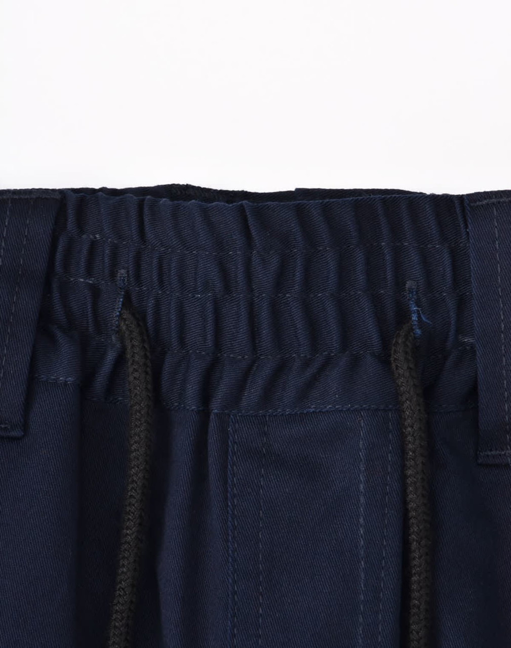 A close-up of navy blue unisex work shorts, featuring an elastic waistband and drawstring with pockets.