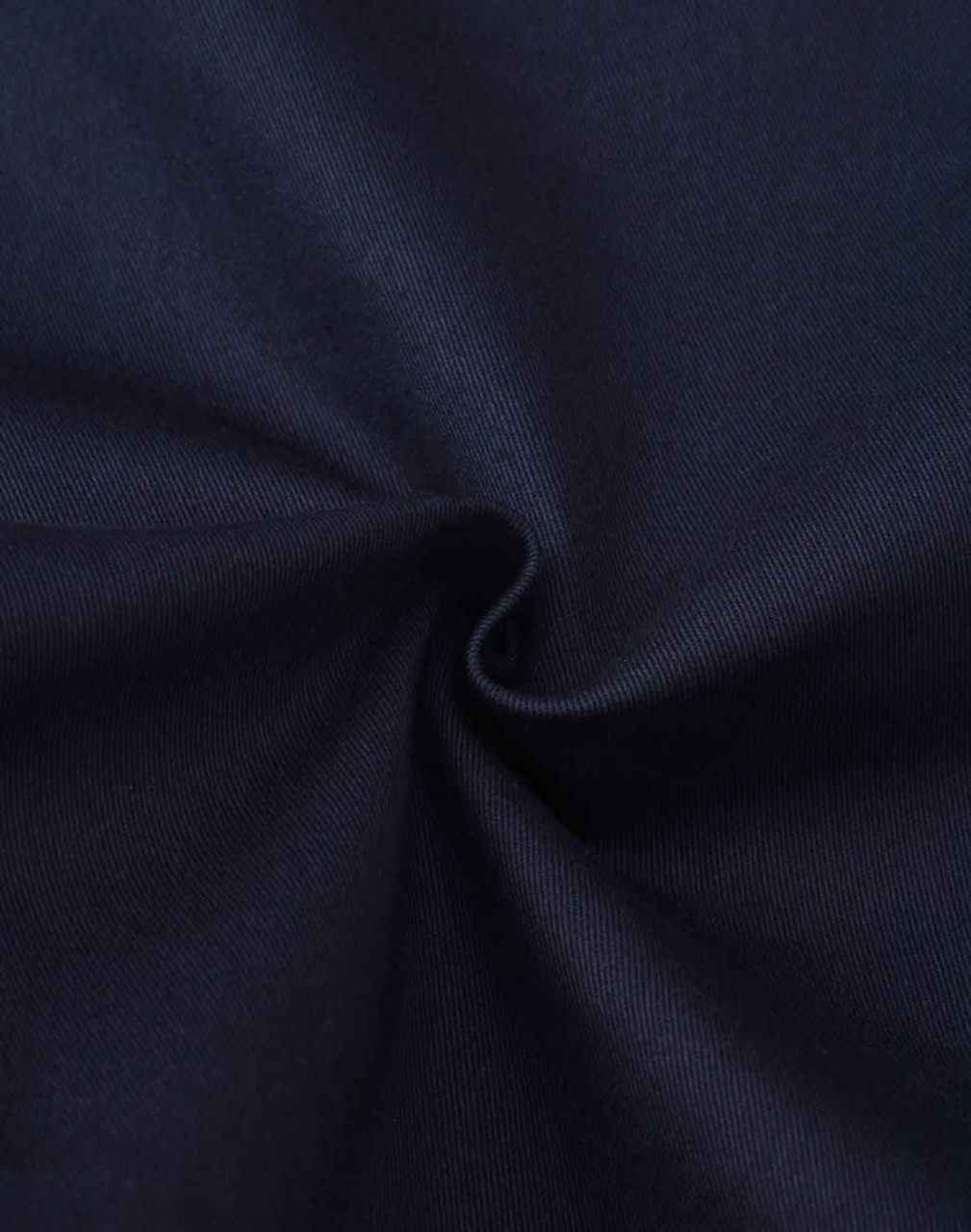A close-up view of dark blue cotton fabric, showing its smooth texture and stretch quality.