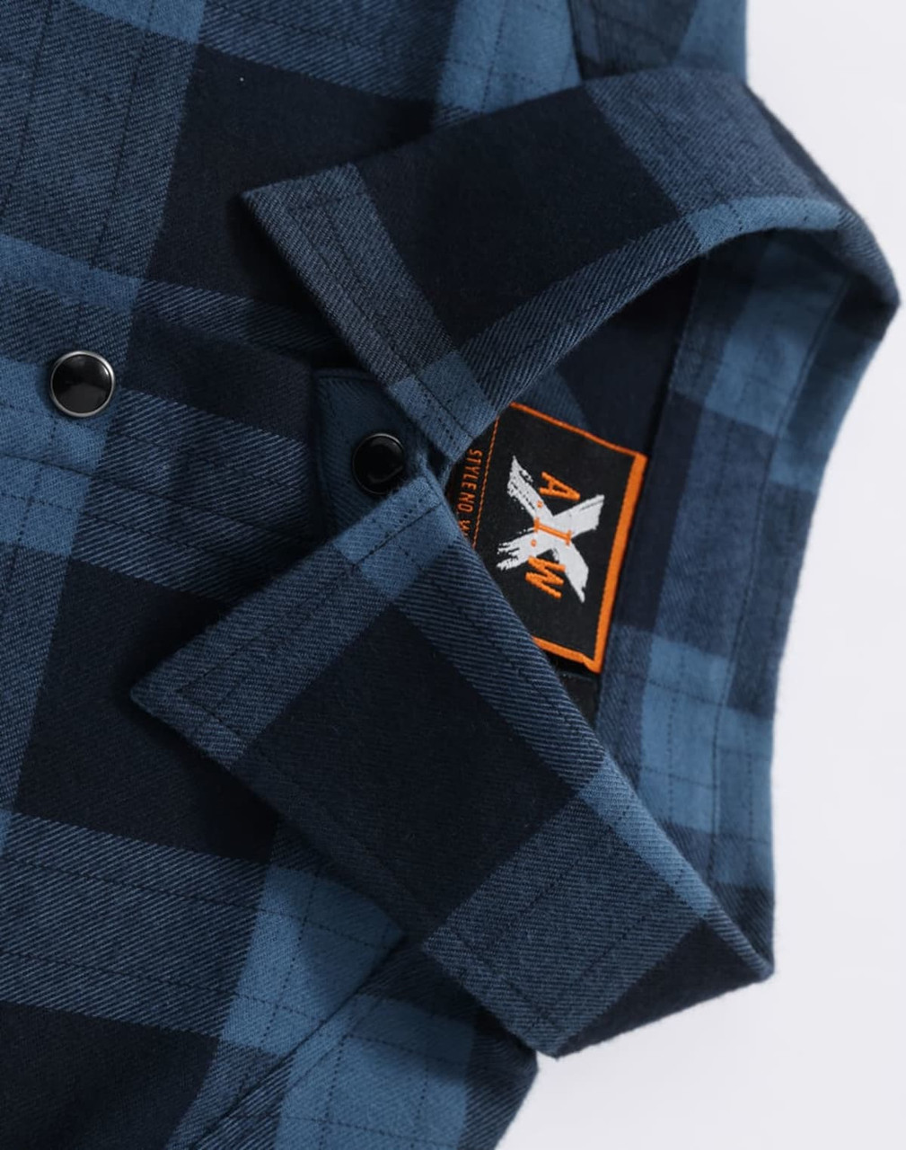A blue and black plaid unisex flannel shirt with a collar and buttons, featuring a logo.