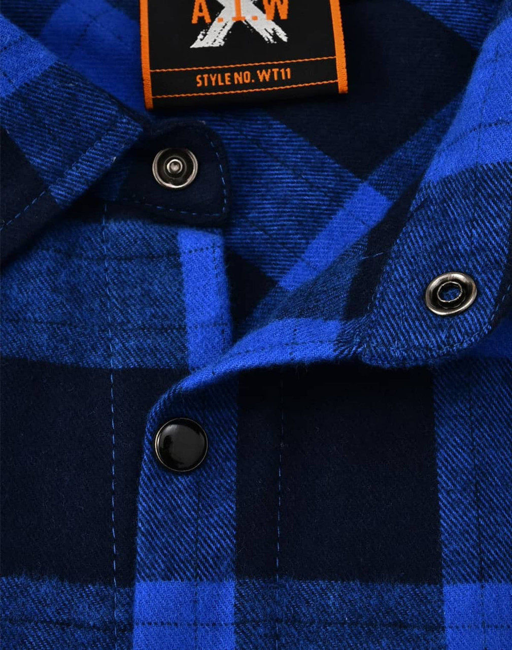 A close-up of a navy and blue flannel plaid button-up shirt featuring black buttons and a brand label.