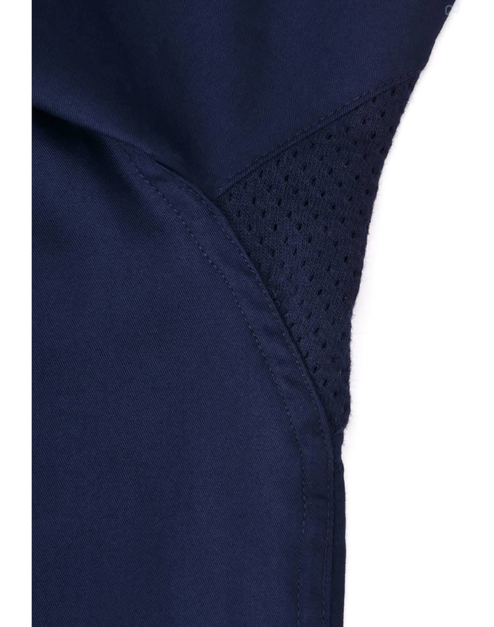 A close-up of a navy blue work shirt featuring a mesh panel for ventilation, with stitching details visible.
