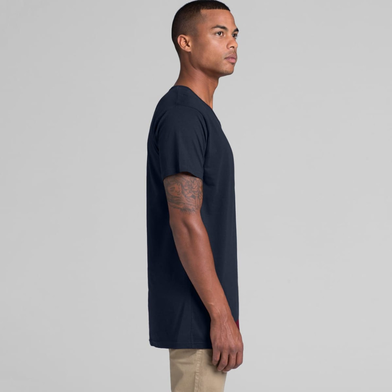A navy blue T-shirt on a model, featuring a simple design and a logo on the front.