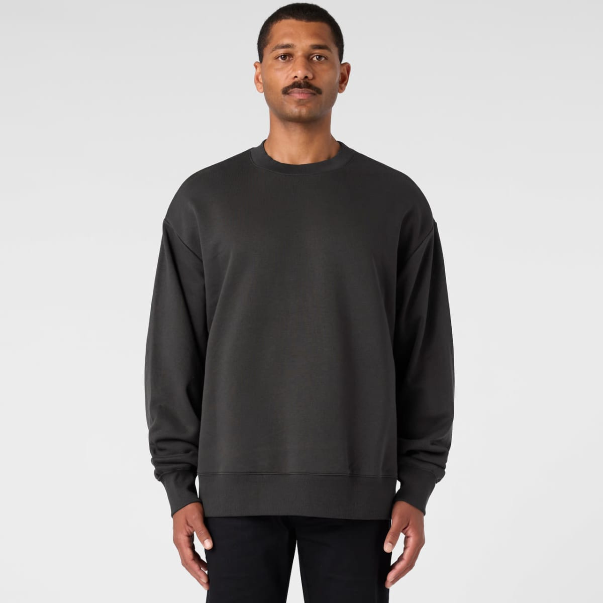 A dark grey sweater with a relaxed fit, featuring long sleeves and a crew neckline. It has a logo on it.