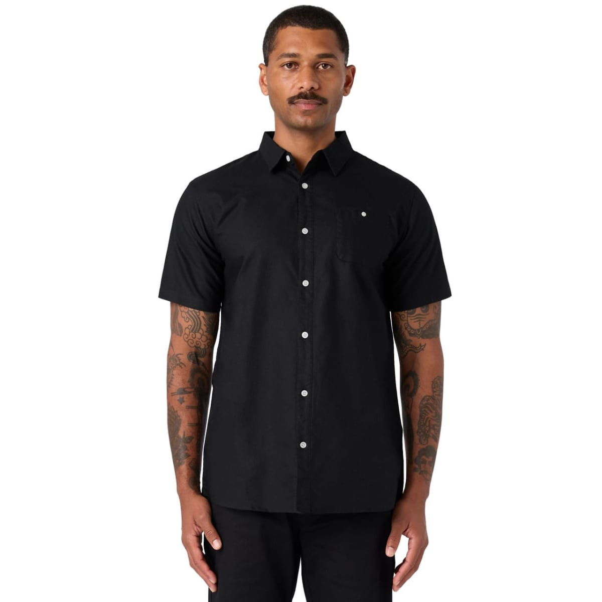 A black short-sleeve button-up shirt worn by a model, featuring a subtle logo.