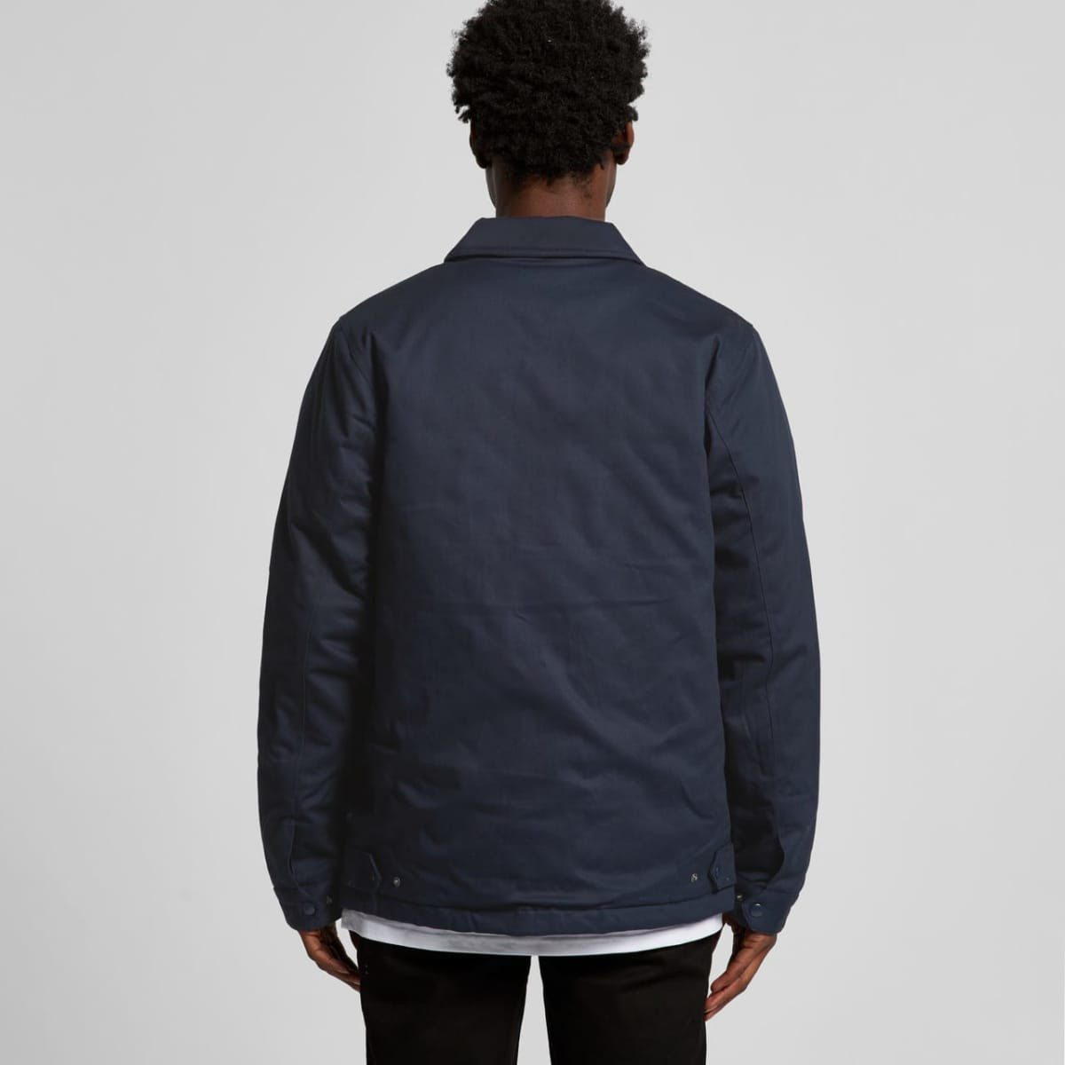 A navy work jacket with a simple design, featuring a collar and a logo on the back.