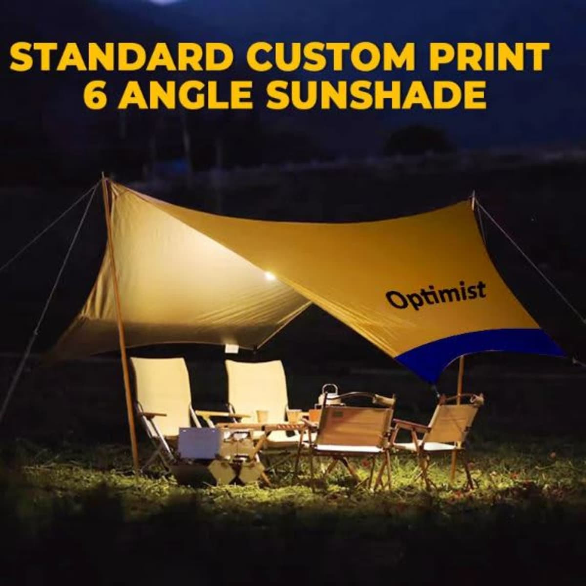 A yellow camping canopy with six angles set up outdoors, accompanied by chairs and a table. It has a logo.
