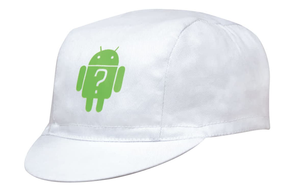 A white cycling cap featuring a green logo on the front. The cap has a classic design with a stiff brim.