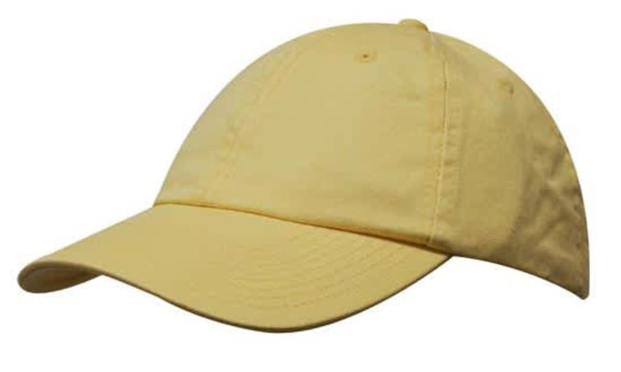 A yellow washed chino twill cap featuring a curved brim and a logo on the front. A yellow washed chino twill cap featuring a curved brim and a logo on the front.