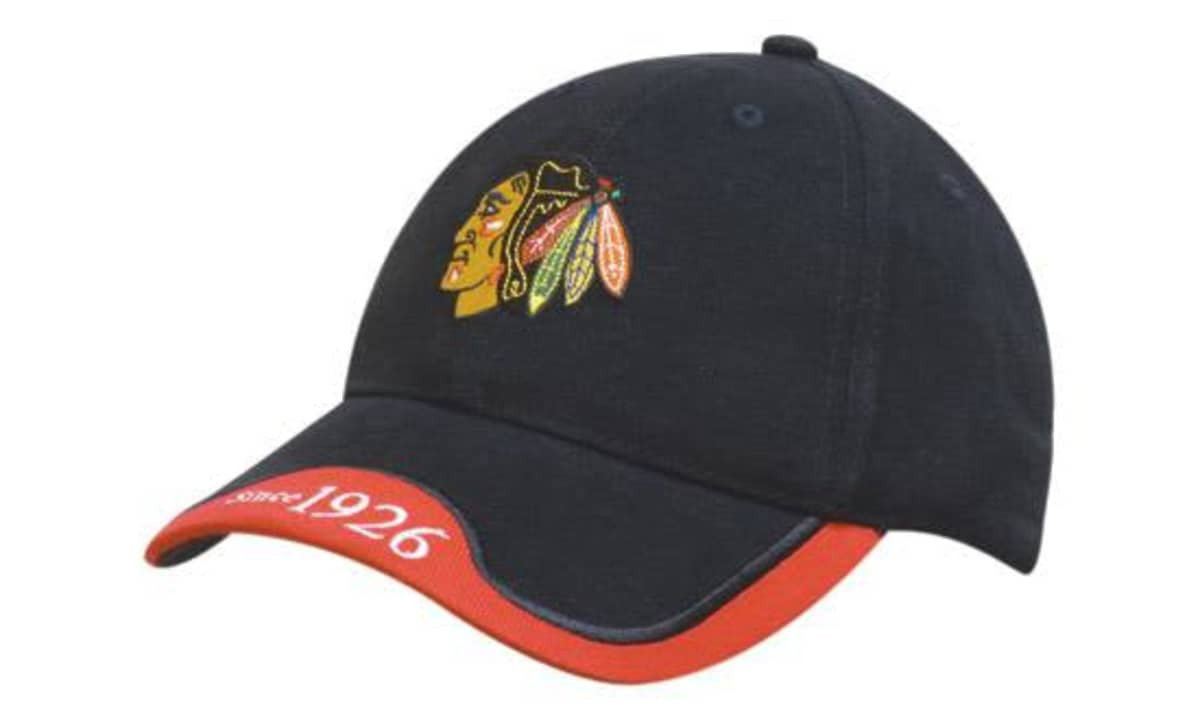 A black cap with a peak indent and embroidered trim, featuring a logo and red accents.