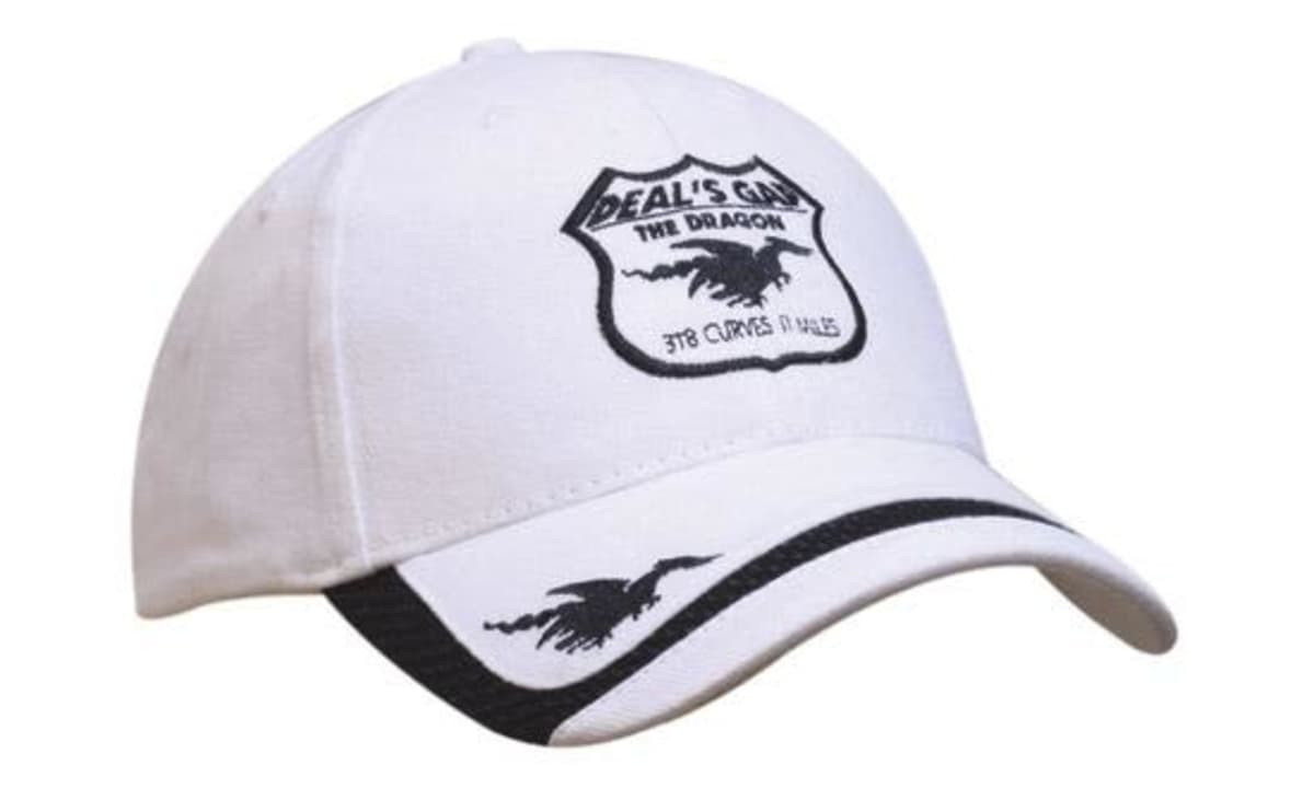 A white cap with a black logo and stitching, featuring a mesh peak indent and a shield-shaped design.